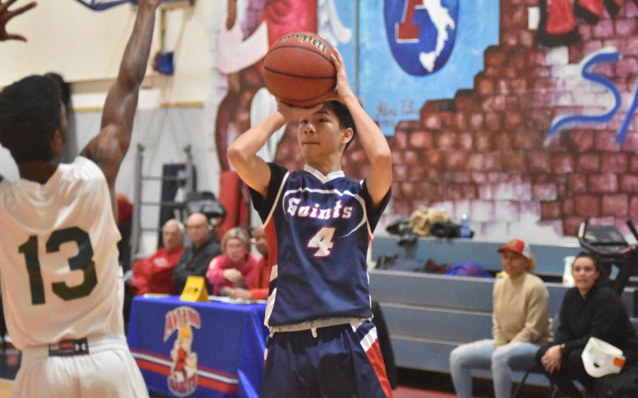 Aviano's Joseph Guerrero goes up for a shot before Naples' Chris White can get to him in the Saints' 56-50 victory on Saturday, Jan. 7, 2023.