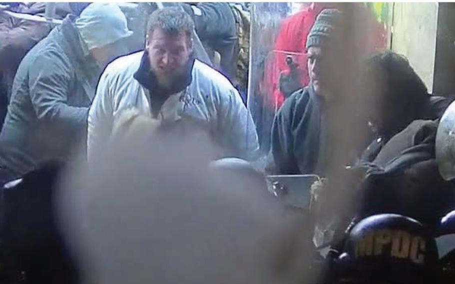 Kyle Fitzsimons, center in light-colored jacket, in a video still from a surveillance camera at the U.S. Capitol on Jan. 6, 2021. 