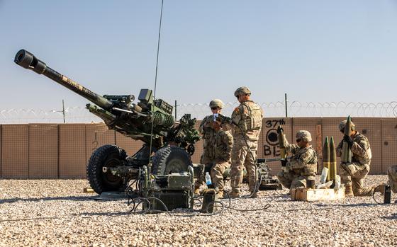U.S. soldiers from the 10th Mountain Division fire artillery during an exercise at al Asad Air Base in Iraq on Dec. 1, 2023. The base has been a target of attacks by Iranian-backed militants.
