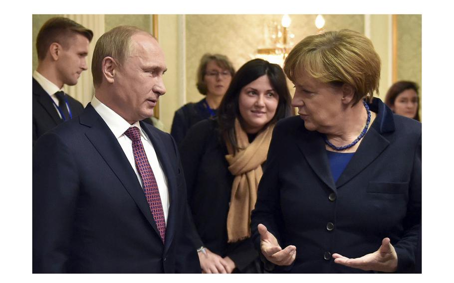 Russian President Vladimir Putin and German Chancellor Angela Merkel talk in Minsk, Belarus, on Feb. 11, 2015.