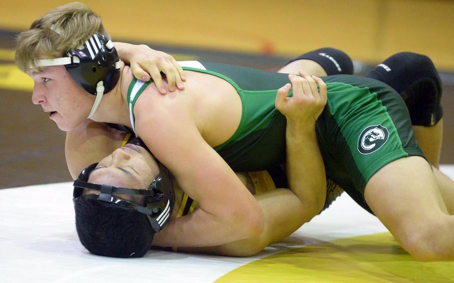 Kubasaki 145-pounder Brady Potter pins Kadena's Joseph Oh in 1 minute, 30 seconds during Wednesday's Okinawa wrestling regular-season finale. The Panthers won the meet 34-28, completing a six-meet regular-season sweep of the Dragons.