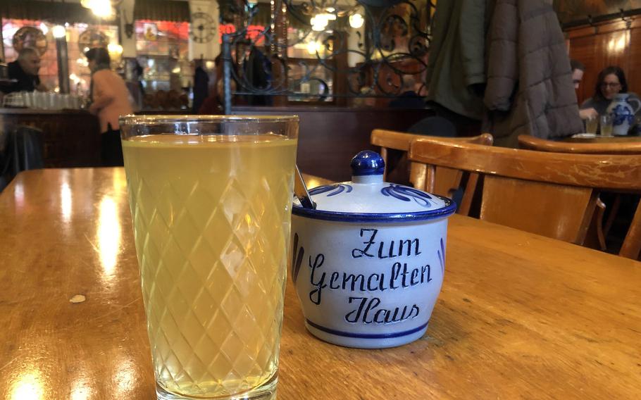 A glass of apple wine at Zum Gemalten Haus, the popular apple wine tavern in the Sachsenhausen district of Frankfurt, Germany. 