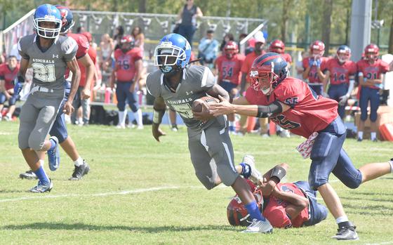 After a teammate slowed him down, Aviano's Joshua Barthold grabs Rota's Kiviti Golfried from behind in the Saints' 42-0 victory over the Admirals on Saturday, Sept. 10, 2022.