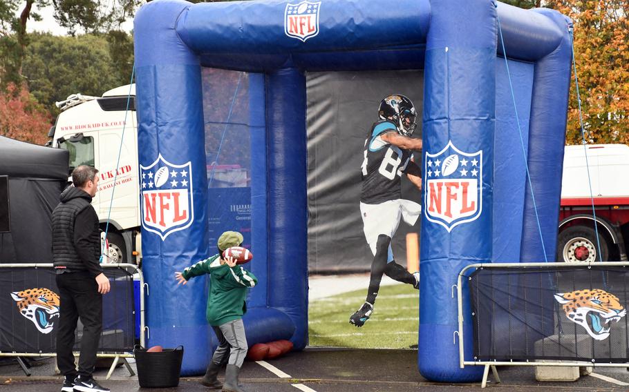 A child hurls a pass at the NFL Experience during the grand opening of the USO at RAF Lakenheath, England, on Nov. 4, 2021. 