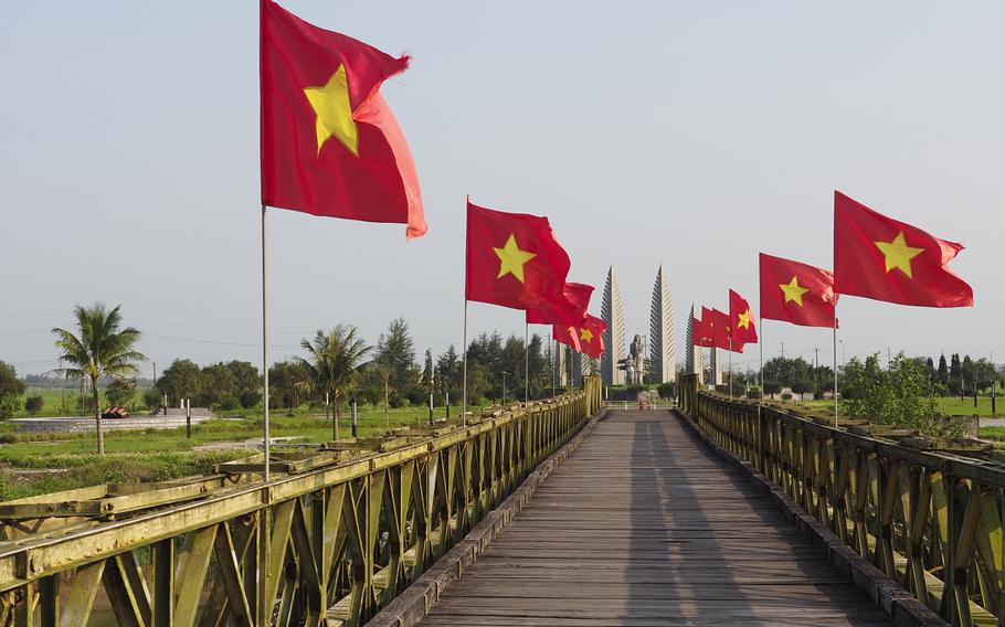 Vietnamese flags fly on the Hien Luong Bridge at the former border between North and South Vietnam.