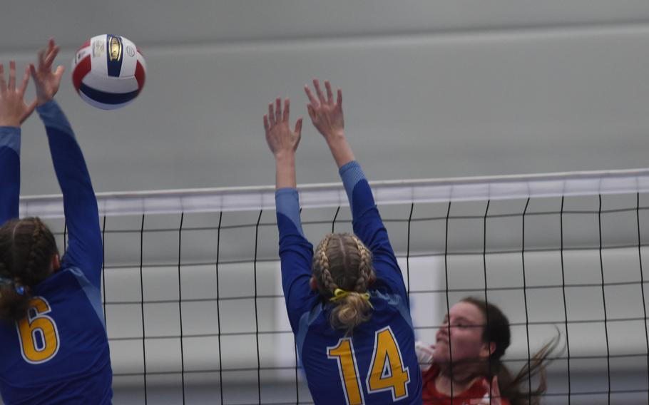 Wiesbaden’s Lorelei Kemmer, left, and Elizabeth Troxel try to block a hit by Kaiserslautern’s Sage Barnes during the DODEA-Europe Division I girls’ volleyball championship on Saturday, Oct. 29, 2022, at Ramstein High School in Germany. Wiesbaden won the match in four sets.