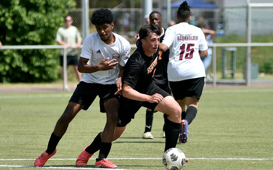 Spangdahlem midfielder Logan Simmers gets by Baumhodler senior Sam Senatus during the second day of pool-play action at the 2025 Division III DODEA European championships on May 20, 2025, at Rothenborn Stadion in Landstuhl, Germany.