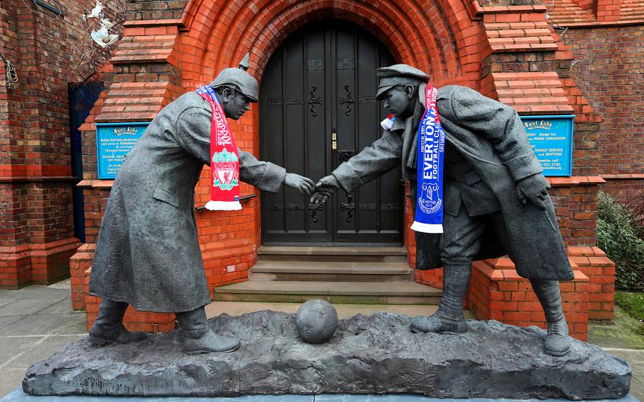In this photo from Feb. 7, 2015, Liverpool and Everton scarves adorn a Christmas Truce statue outside a church near the stadium before the Barclays Premier League match between Everton and Liverpool at Goodison Park in Liverpool, England. 