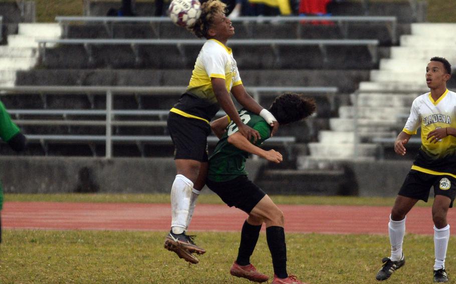 Kadena's Derek Vaden climbs over the back of Kubasaki's Frank Stare to head the ball during Wednesday's Okinawa boys soccer match. The Panthers won 3-2.