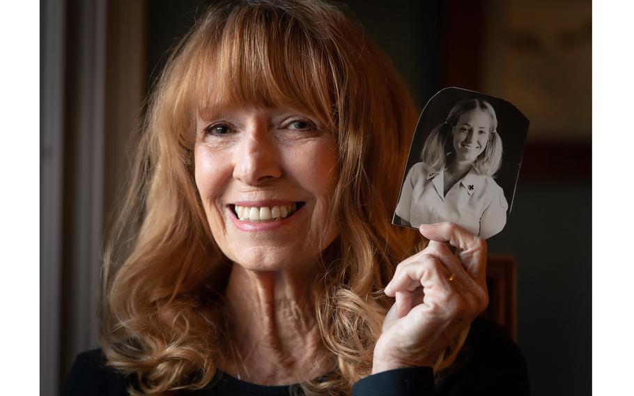 Karen K. Jankowski, at her home in Peachtree City, Ga., shows a photo of herself from the Vietnam War, when she was one of the "Donut Dollies" who visited the troops. 