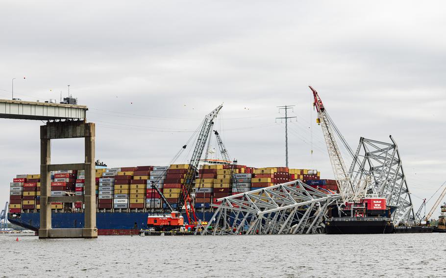 The wreckage of the collapsed Key Bridge and the Dali cargo ship are seen from Fort Armistead Park in Baltimore on April 25. 