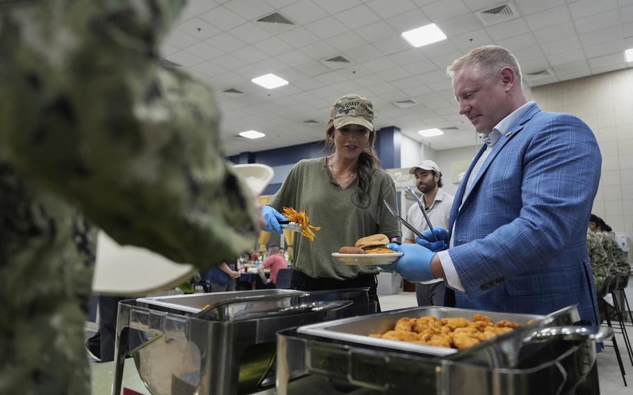 Kristi Noem and Sean Plankey serving meals at a Naval Support Activity.