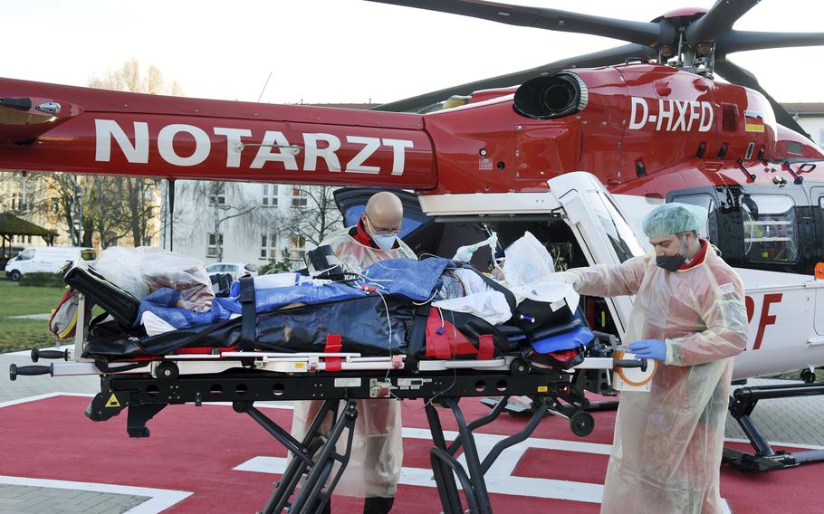 From the Corona intensive care unit of the Paul Gerhard Stift Evangelical Hospital, a pregnant woman suffering from COVID-19 is taken to the DRF helicopter by Air Rescue emergency in Wittenberg, Germany, Friday, Dec. 3, 2021.