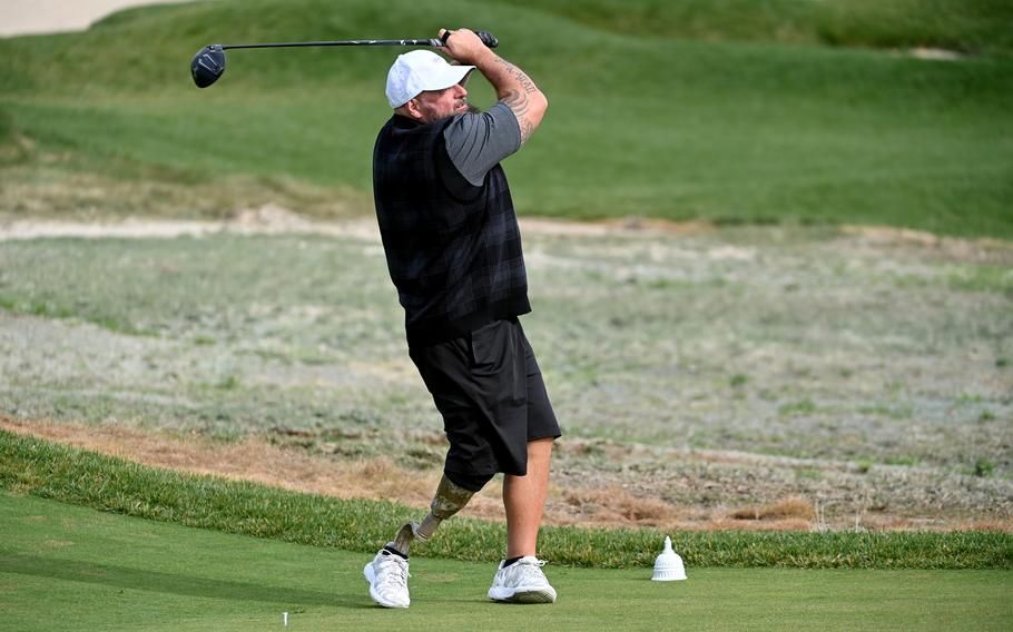 Marine veteran Chris Nowak tees off during the PGA Hope event at Congressional Country Club in Bethesda, Md.