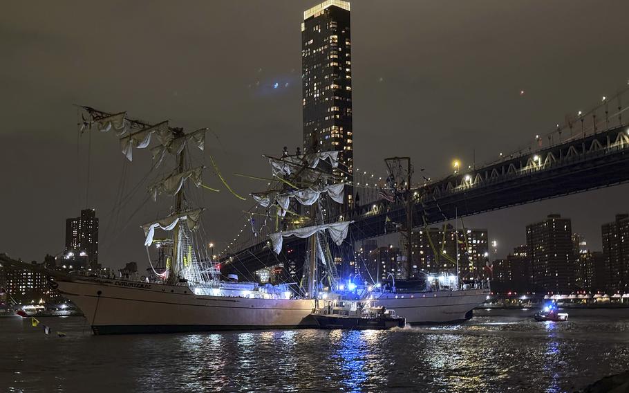 A masted Mexican navy training ship, the Cuauhtemoc, sits stranded after colliding with the Brooklyn Bridge.