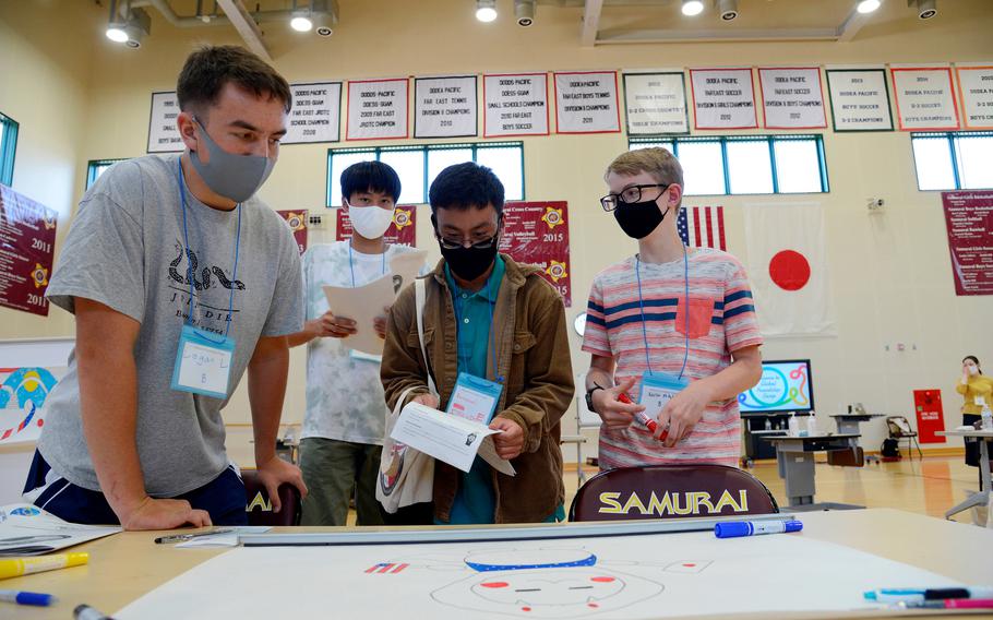 American and Japanese students work on a project during a cultural-exchange camp at Matthew C. Perry High School on Marine Corps Air Station Iwakuni, Japan, Sunday, Oct. 3, 2021.