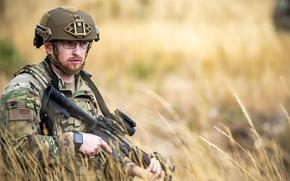 Airman 1st Class Isaac John holds his position during a field training exercise at Stanford Training Area, England, Aug. 17, 2022. The House Armed Services Committee approved an amendment that would mandate a three-year Air Force test program to study the effects of beard-wearing in the service.