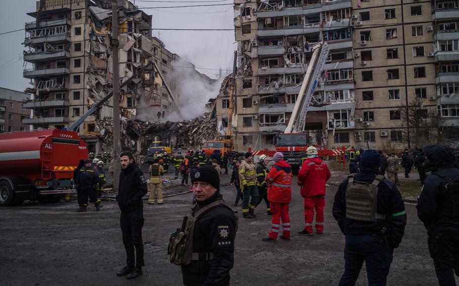 Rescuers continue to search for survivors in the ruins of a residential apartment complex that was hit by a Russian strike the day before in Dnipro, Ukraine, on January 15, 2023.