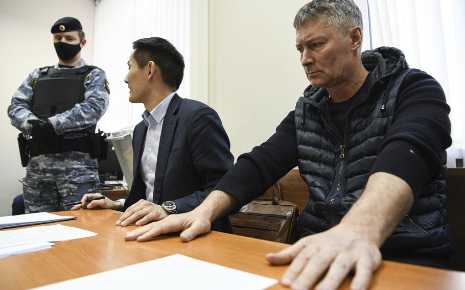 Yevgeny Roizman, former mayor of Russia’s fourth-largest city, right, sits in a courtroom in Yekaterinburg, Russia, Thursday, March 16, 2023. Roizman has been detained on charges that could land him behind bars as part of authorities’ efforts to muzzle dissent. Yevgeny Roizman is a sharp critic of the Kremlin and one of the most visible and charismatic opposition figures in Russia.
