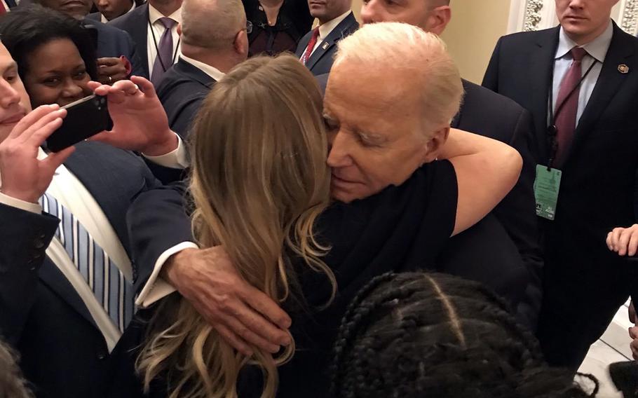Brittany Alkonis, wife of Navy Lt. Ridge Alkonis, who is imprisoned in Japan, hugs President Joe Biden following his State of the Union address at the Capitol, Tuesday, Feb. 7, 2023.
