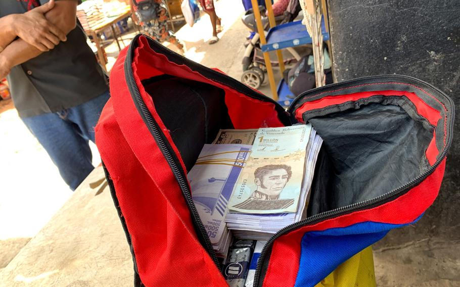 A street vendor with a backpack of Venezuelan bolivars is seen at a public market in Puerto la Cruz, Venezuela on Oct. 14, 2021. 