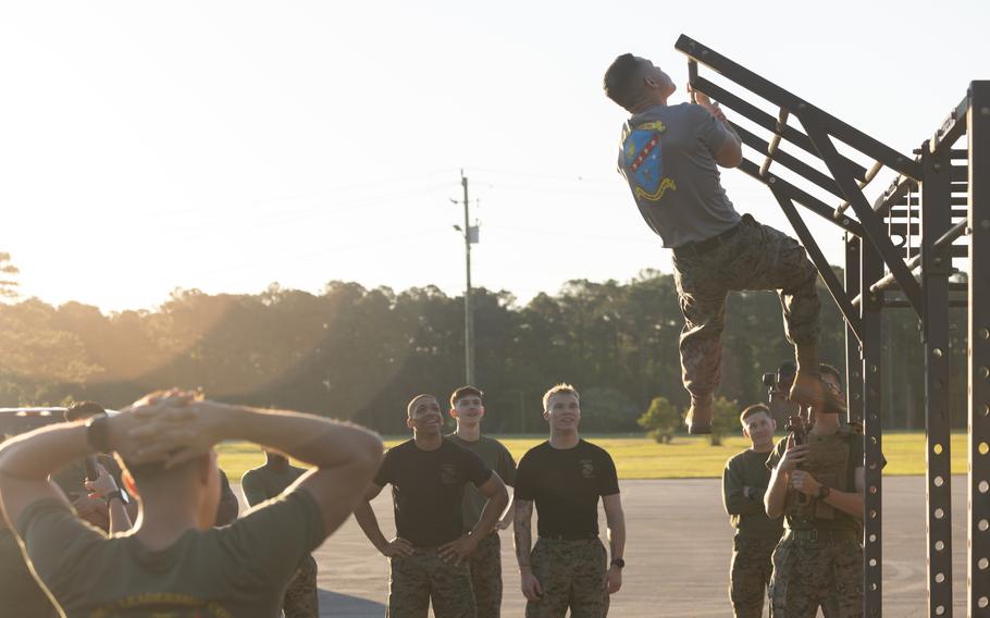 A Marine performs one-handed pull-ups