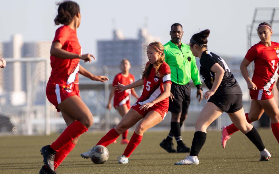 Victoria Justice has the ball in a crowded spot on the field.