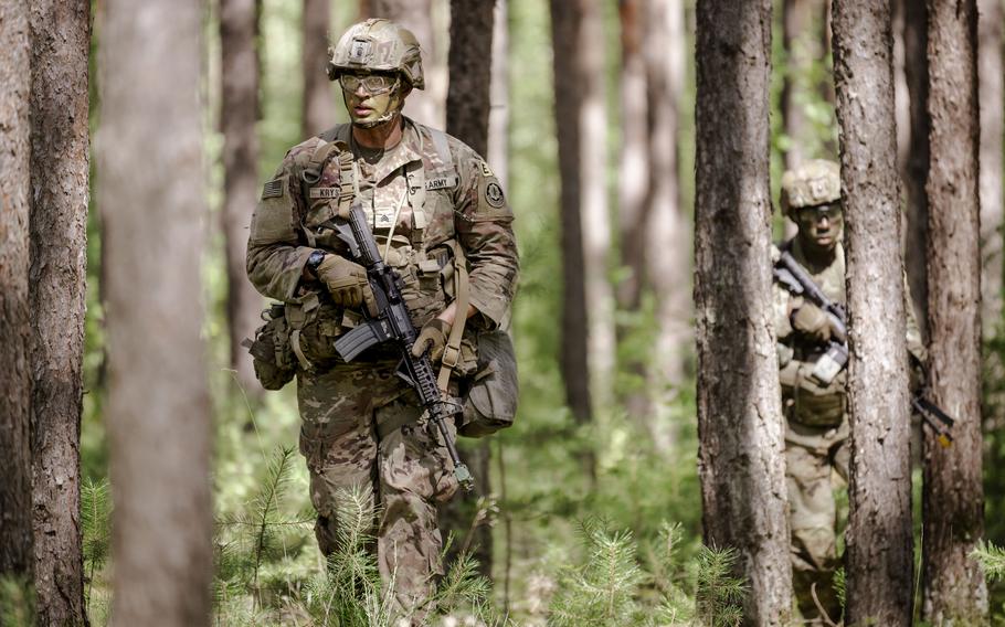 An Army soldier patrols with his squad