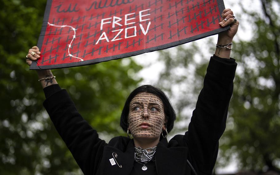 A woman holds a “Free Azov” sign during a rally aiming to raise awareness on the fate of Ukrainian prisoners of war in Kyiv, Ukraine, Sunday, April 21, 2024.