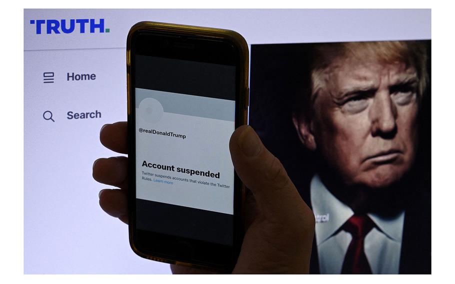 The suspended Twitter account of former President Donald Trump is displayed on a mobile phone with Trump’s Truth Social page shown in the background on Oct. 28, 2022, in Washington, DC. 