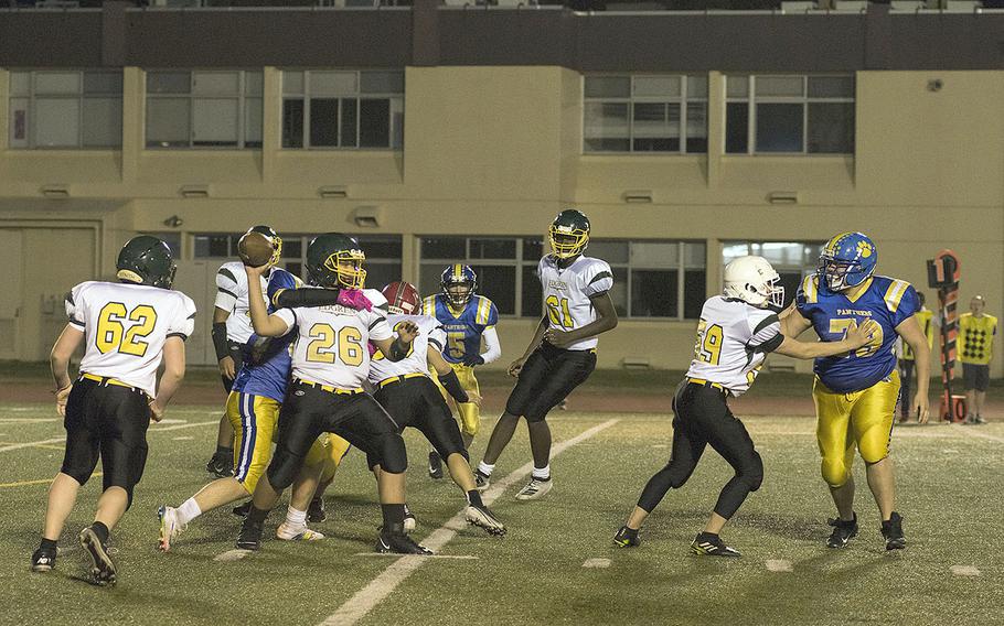 Robert D. Edgren's Jayse Ulechong gets tackled while passing the football during the homecoming game against Yokota, Friday, Nov. 5, 2021. 