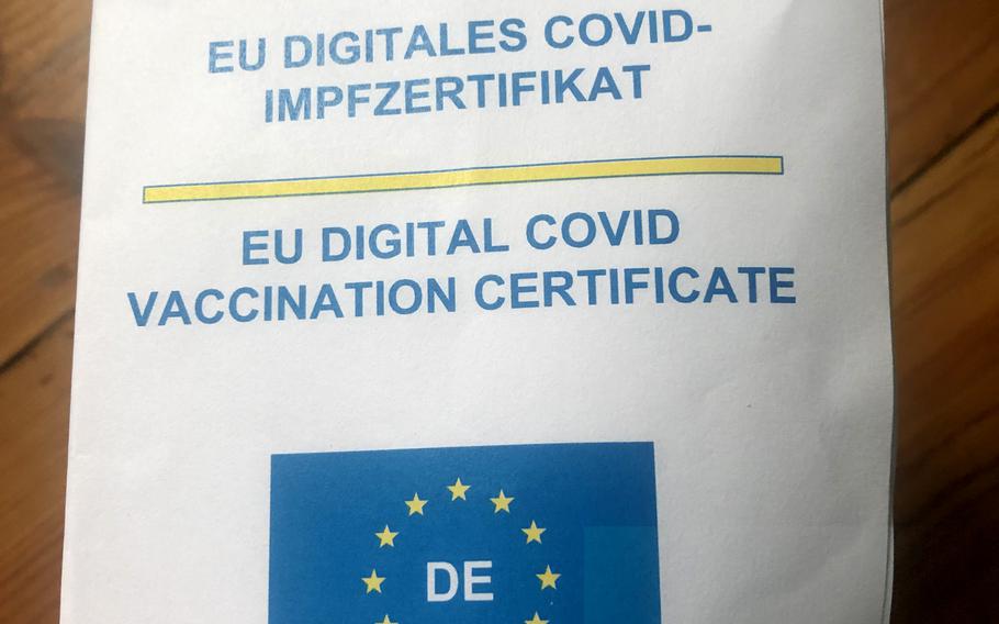 The print-out of a the EU digital COVID-19 vaccination certificate delivered to a U.S. citizen in Kaiserslautern, Germany, June 22, 2021, can be folded in four or uploaded to the Corona-Warn app or the CovPass app. 