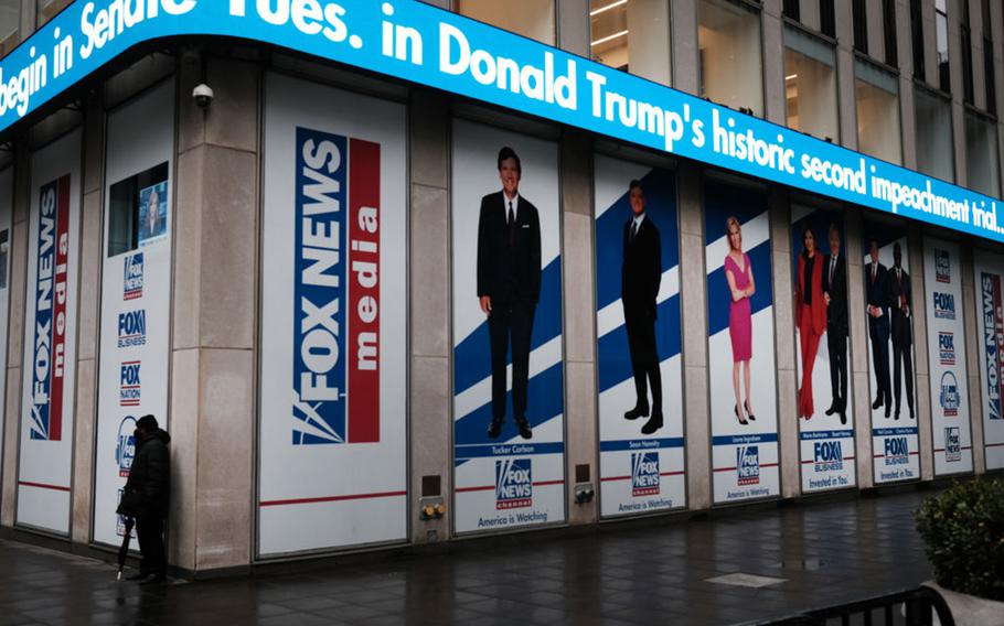 News headlines on the impeachment trial of Donald Trump are displayed outside the Fox headquarters on Feb. 9, 2021, in New York City. 