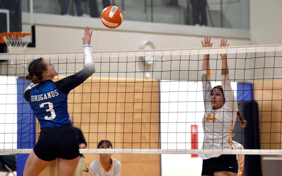Brussels middle hitter Lucia Martinez attempts to dink the ball over the Sentinels' Maxine Diaz during a scrimmage at Spangdahlem High School in Spangdahlem, Germany, on Sept. 1, 2023.
