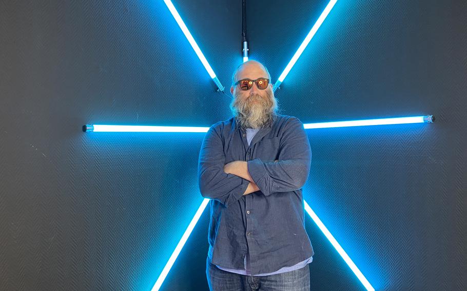 Chad Garland tries to look cool in front of a light feature Oct. 21, 2021, at SnapMySelf, a ''selfie museum'' in downtown Kaiserslautern, Germany. Visitors can choose from various sets or backdrops for social media self-portraits.
