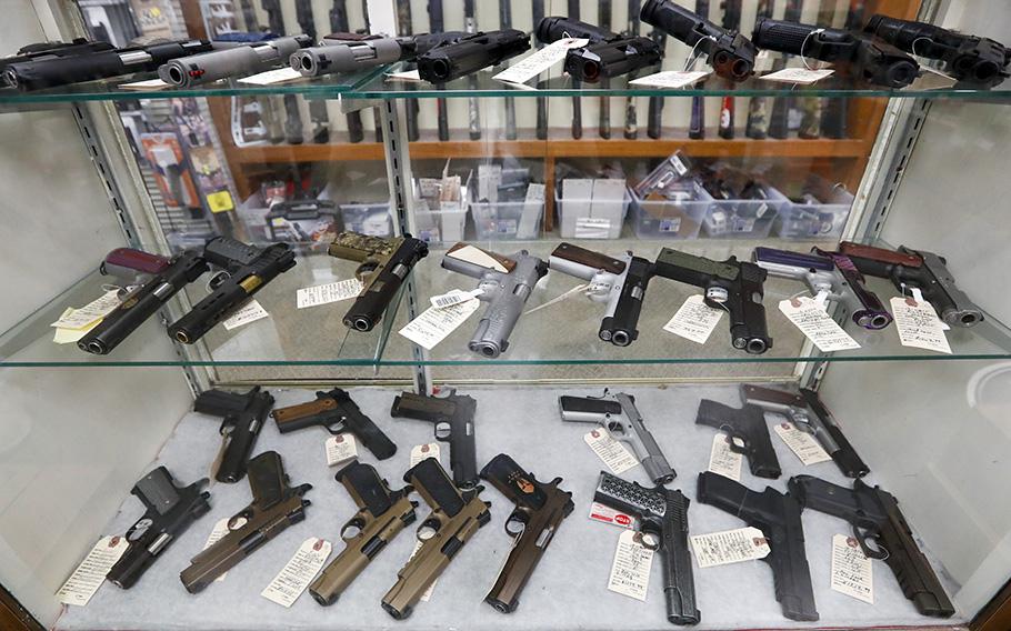 Semi-automatic handguns are displayed at shop in New Castle, Pa., March 25, 2020. A federal appeals court has dealt a legal setback to the Biden administration on guns in a lawsuit challenging tighter regulations on stabilizing braces.