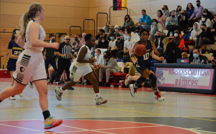 Ansbach's Heaven Jackson pushes past AFNORTH's Sheckinah Boswell during the DODEA-Europe Division III girls basketball title game in Kaiserslautern, Germany, on Saturday, Feb. 26, 2022.