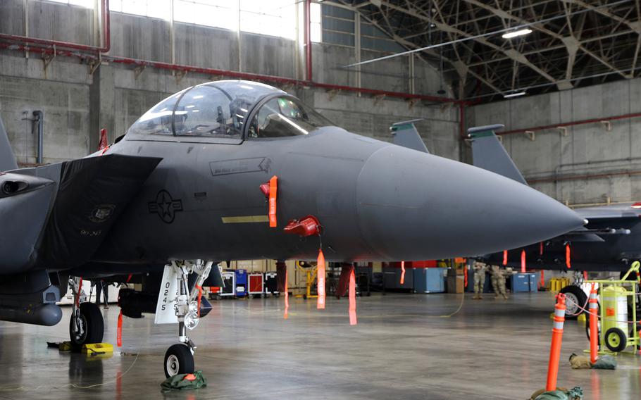 An F-15E Strike Eagle, temporarily deployed from the 391st Fighter Squadron at Mountain Home Air Force Base, Idaho, rests in a hangar at Kadena Air Base, Okinawa, Friday, June 16, 2023.