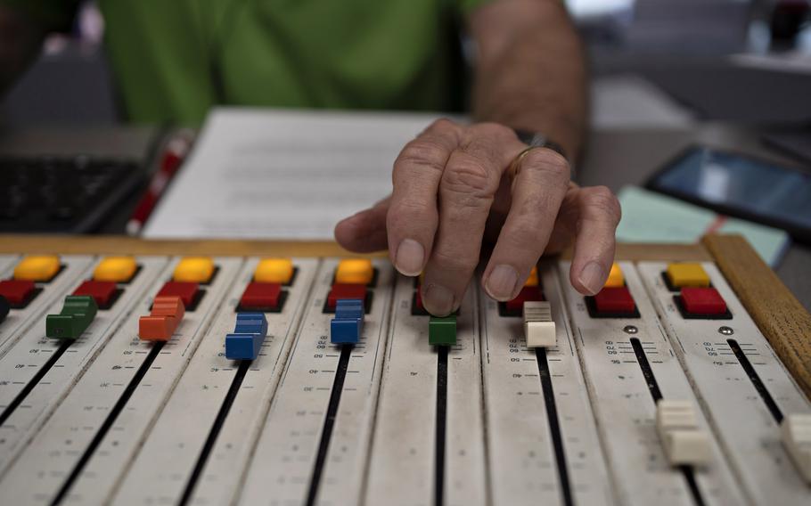 Host Scott DeLucia adjusts the volume during the WTAW morning show, "The Infomaniacs." 