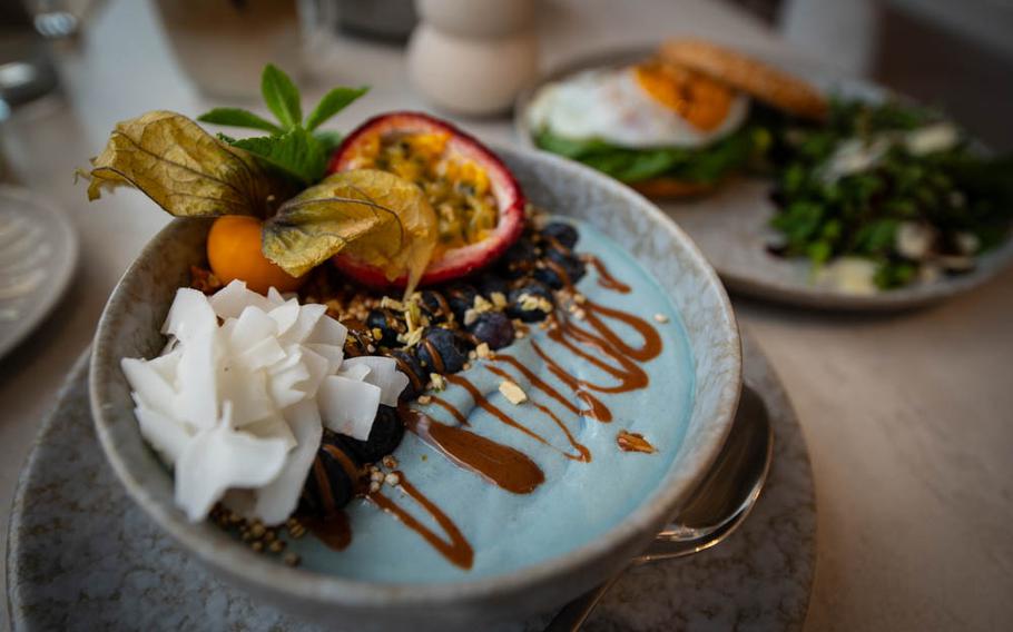 An ocean smoothie bowl at The Parlour in Landstuhl, Germany, comes adorned with coconut shavings, blueberries, granola and spirulina, topped with homemade granola and passion fruit.