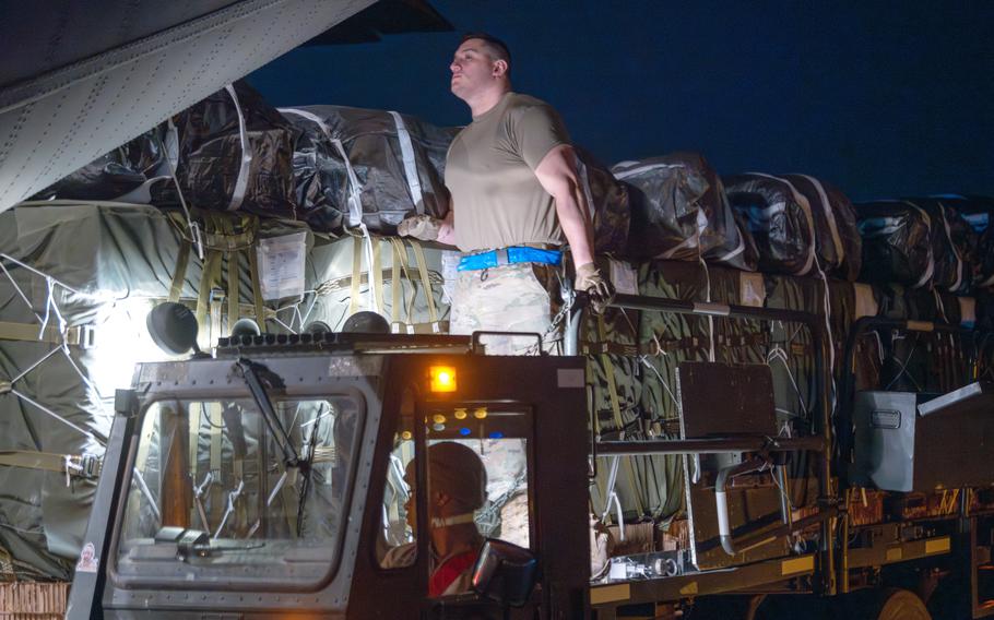 U.S. Air Force aerial port airmen load pallets of food and water destined for a Gaza airdrop aboard a C130-J Hercules on March 1, 2024.