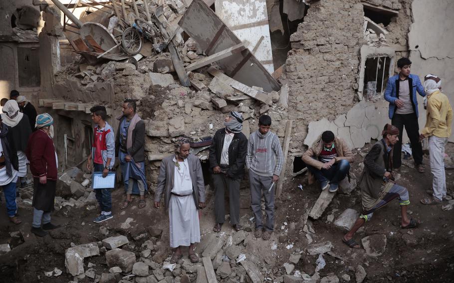People gather at the site of a Saudi-led airstrike near Yemen’s Defense Ministry complex in Sanaa, Yemen, on Nov. 11, 2017.