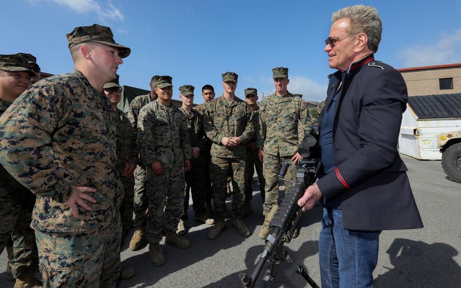 “Karate Kid” and “Cobra Kai” actor Martin Kove gets acquainted with a high-powered M240 Bravo machine gun during a visit to the 5th Marine Regiment motor pool facility at the San Mateo area of the base on Thursday, March 10, 2022 in Camp Pendleton, Calif. Close at left is 2nd Lt. Christopher Deddo.
