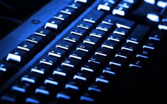 A blue lit computer keyboard.