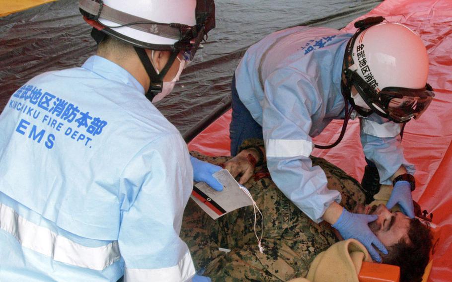 Marine Corps and Japanese first responders train to a handle a military helicopter crash at Camp Hansen, Okinawa, Thursday, Feb. 9, 2023.