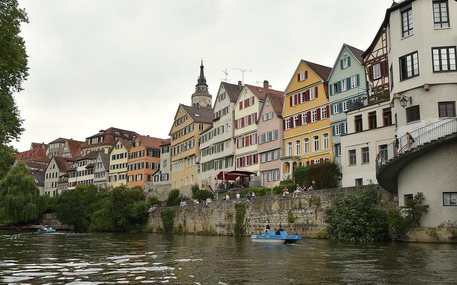 Colorful houses line a river’s bank.