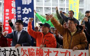 Protesters chant anti-Osprey slogans during a rally outside the Okinawa Defense Bureau in Kadena town, Okinawa, Dec. 4, 2023. 