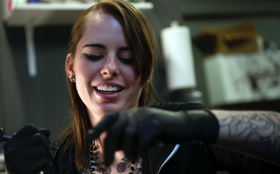 Senior Airman Autumn Rosado works on a tattoo at Sacred Art tattoo shop in Abilene, Texas, Sept. 19, 2019.