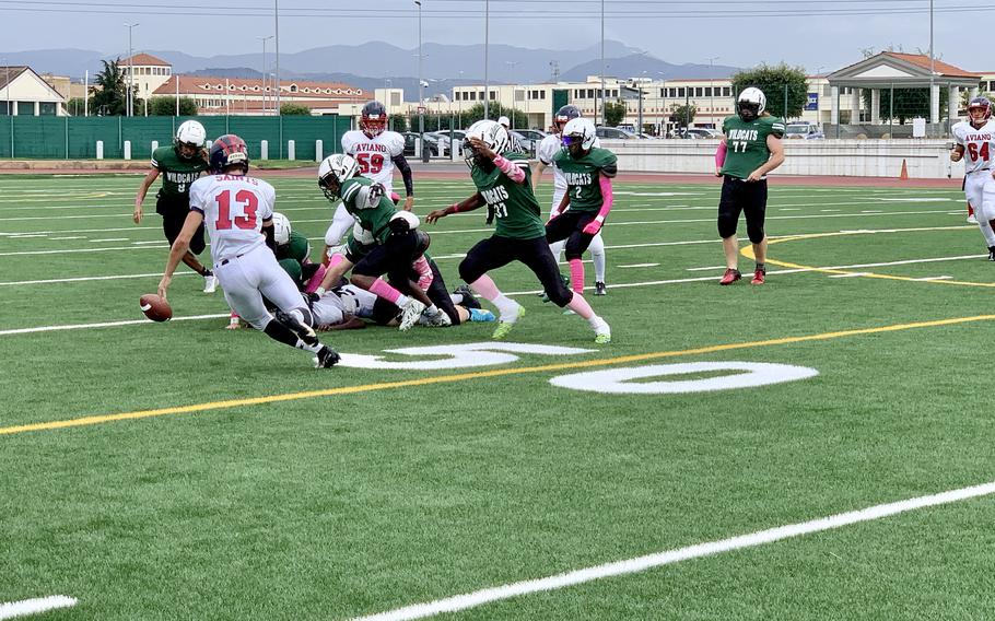 Aviano and Naples players scramble to take possession of a loose ball during Saturday's DODEA European Division II championship game at Naples. Tough defense by both teams put offensive squads to the test, resulting in several fumbles and interceptions.