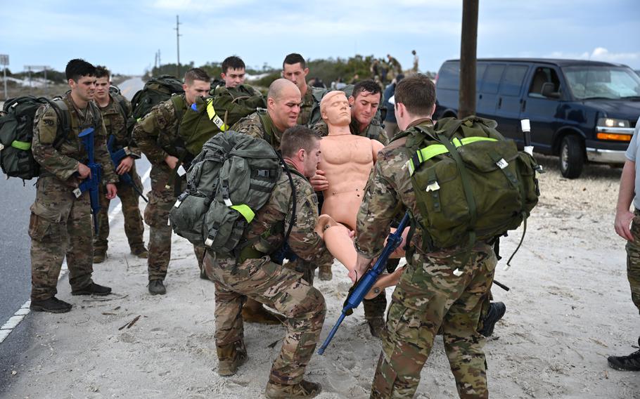 U.S. Air Force special tactics and combat rescue officer candidates carry a medical dummy during an assessment and selection at Hurlburt Field, Fla., on March 22, 2021.